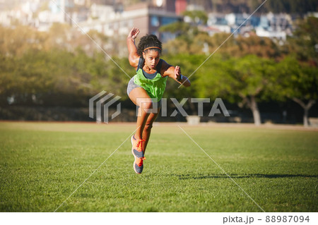 Sprint to the finish line of your goals. Shot of a sporty young woman exercising outdoors. Sprint to the finish line of your goals. Shot of a sporty young woman exercising outdoors. 88987094