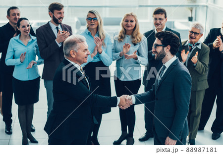 happy business partners shaking hands. the concept of cooperati 88987181