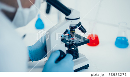 close up. scientist setting up his microscope to work. 88988271