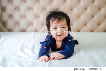 Cute little caucasian baby lying on bed at home. 88988313