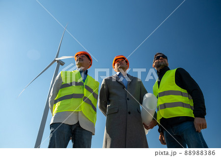 Specialists look at built stations of rotating wind turbines Specialists look at built stations of rotating wind turbines 88988386