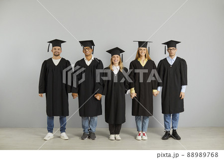 Portrait of diverse college graduates in robes and hats Portrait of diverse college graduates in robes and hats 88989768