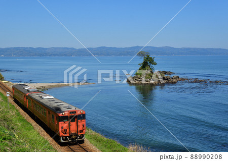 雨晴海岸を走る氷見線の列車 88990208