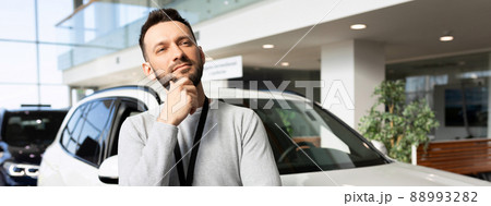 middle-aged man thinking about buying a new car 88993282