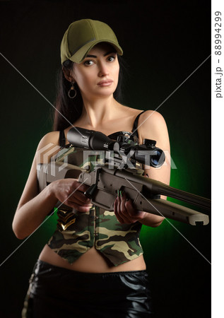 a girl soldier in military clothes with a weapon a girl soldier in military clothes with a weapon 88994299