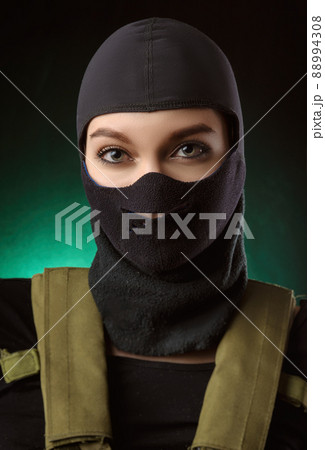 the girl in military special clothes posing with a gun in his hands on a dark background in the haze the girl in military special clothes posing with a gun in his hands on a dark background in the haze 88994308