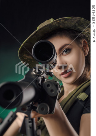 a girl soldier in military clothes with a weapon a girl soldier in military clothes with a weapon 88994309