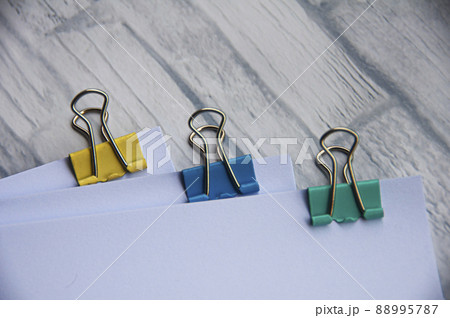 Blank white paper with clip binders on white wooden table. Copy space concept Blank white paper with clip binders on white wooden table. Copy space concept 88995787