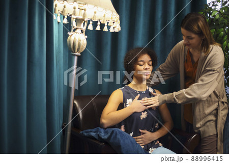 African-American young woman smiling while sitting in psychologist office African-American young woman smiling while sitting in psychologist office 88996415