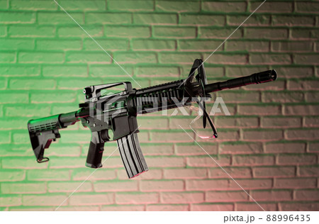American army rifle M4A1 against a brick wall 88996435