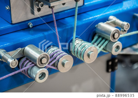 bobbins with rope on the machine of a clothing factory bobbins with rope on the machine of a clothing factory 88996535
