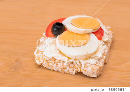 Rice Cake Sandwich with Tomato, Eggs and Olives 88996654