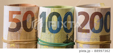 Euro in rolls banner. Fifty, one hundred and two hundred euros are rolled up. 88997362