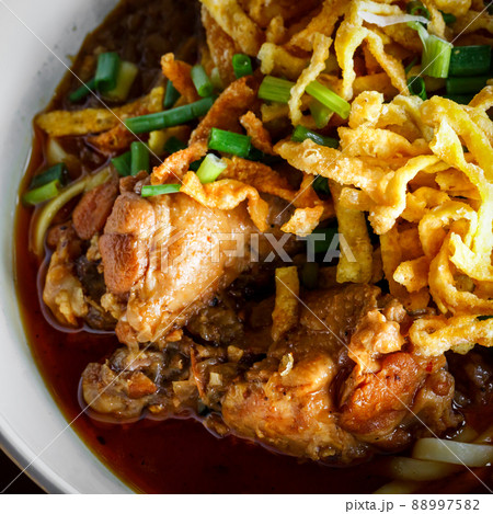 close up Northern Thai Noodle in Chicken coconut milk Curry soup ( Khoa Soi Kai) 88997582