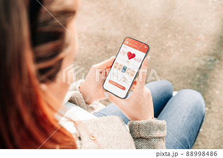 Pregnancy health app. Pregnant woman holding smartphone. Mobile pregnancy online maternity application. Concept of pregnancy, maternity, expectation for baby birth. 88998486