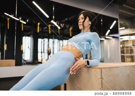 Fitness girl exercising on a wooden box for crossfit 88998998