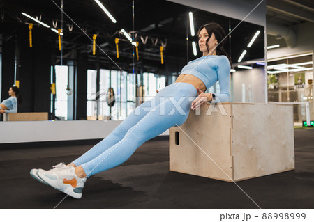 Fitness girl exercising on a wooden box for crossfit 88998999