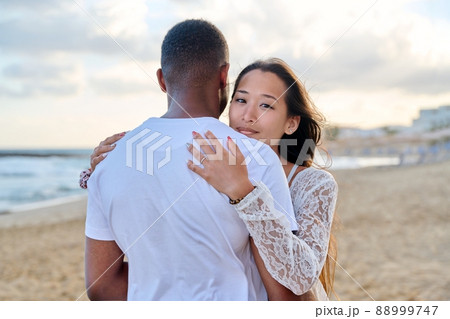 Young loving couple hugging on the beach Young loving couple hugging on the beach 88999747