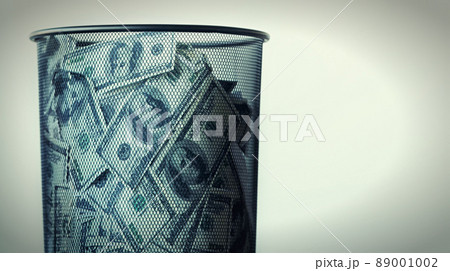 One mans trash is another mans treasure. Studio shot of a waste basket filled with money. One mans trash is another mans treasure. Studio shot of a waste basket filled with money. 89001002