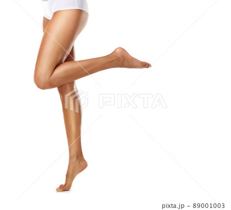 Shes got a leg up on being beautiful. Studio shot of a young woman with gorgeous skin isolated on white. 89001003