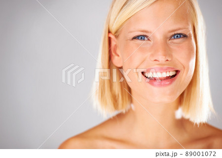 She will bring all the attention here - Copyspace. Portrait of a pretty young woman with a large grin and copyspace beside her. She will bring all the attention here - Copyspace. Portrait of a pretty young woman with a large grin and copyspace beside her. 89001072