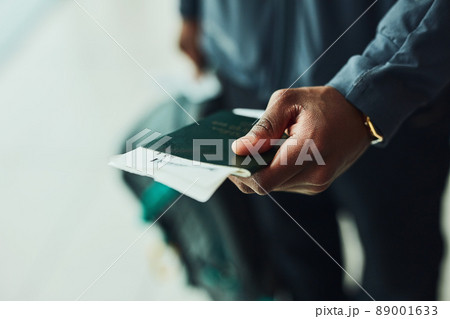 My passport is screaming to be stamped. Shot of an unrecognizable person holding his passport indoors. My passport is screaming to be stamped. Shot of an unrecognizable person holding his passport indoors. 89001633
