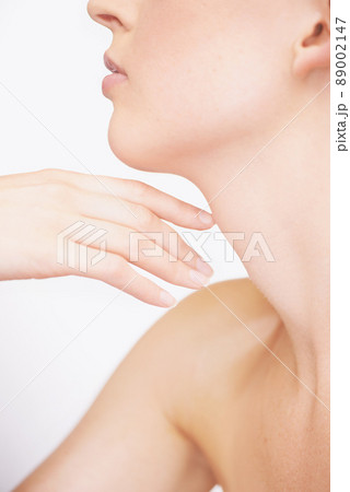 What beautiful skin. Cropped view of a young woman touching her shoulder. 89002147