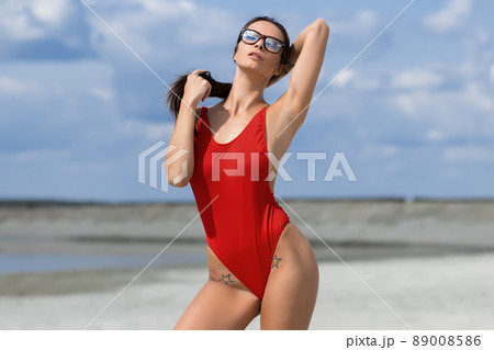 Beautiful woman in swimsuit on beach Beautiful woman in swimsuit on beach 89008586