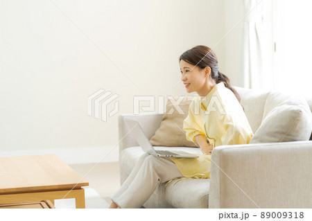 お腹を抑える女性　主婦　ママ 89009318