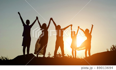 happy family parents holding hands raised their hands up. dad mom daughter and son are dream happy in park. happy family parents holding hands raised their hands up. dad mom daughter and son are dream happy in park. 89013694