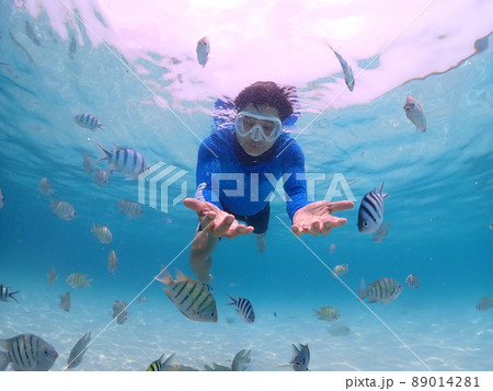 Tourist people diving with snorkel to see nemo fish , beautiful fish and coral at Samaesarn Island of Thailand 89014281