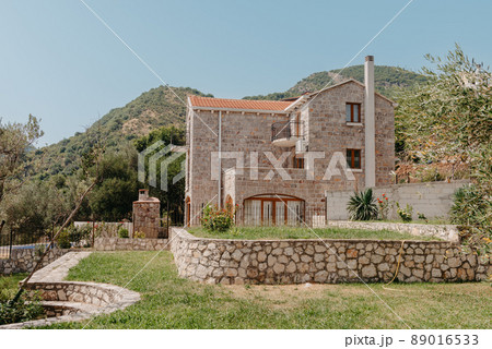 Cozy villa patio with decorative plants and wooden flooring at sunset Cozy villa patio with decorative plants and wooden flooring at sunset 89016533