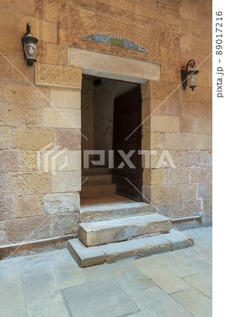 Ancient decorated bricks stone wall and doorway leading to the House of Egyptian Architecture historical building, Cairo, Egypt 89017216