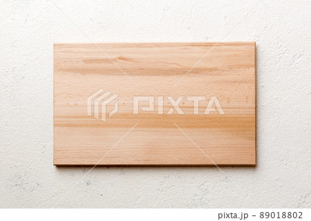Top view of wooden cutting board on cement background. Empty space for your design 89018802
