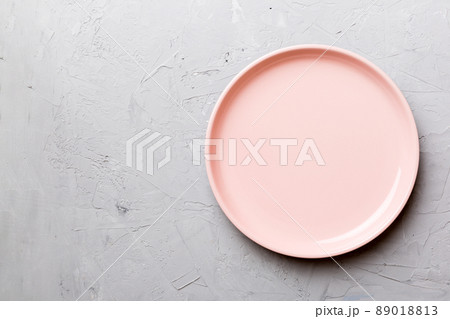 Top view of empty pink plate on cement background. Empty space for your design 89018813
