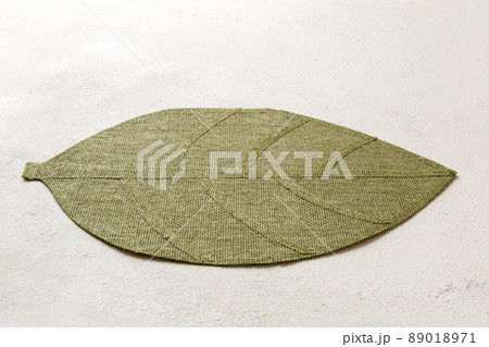 Perspective view of leaf shaped tablecloth for food on cement background. Empty space for your design. Perspective view of leaf shaped tablecloth for food on cement background. Empty space for your design. 89018971