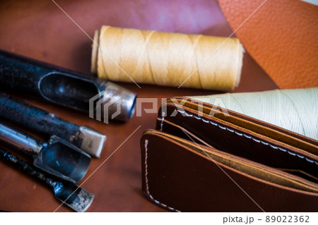 Genuine cowhide leather wallet handmade with tool top view Genuine cowhide leather wallet handmade with tool top view 89022362