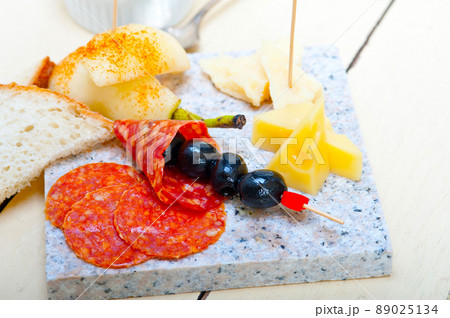 mix cold cut on a stone with fresh pears 89025134