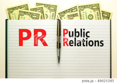 PR public relations symbol. Concept words PR public relations on white note. Metallic pen. Dollar bills. Beautiful white background. Copy space. Business and PR public relations concept. PR public relations symbol. Concept words PR public relations on white note. Metallic pen. Dollar bills. Beautiful white background. Copy space. Business and PR public relations concept. 89025385