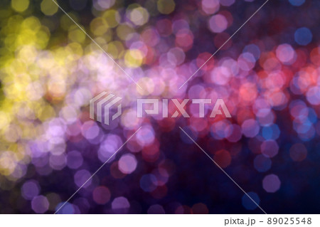 Blur sparkles. Defocused pink yellow purple color gradient shiny grain texture on dark background. 89025548