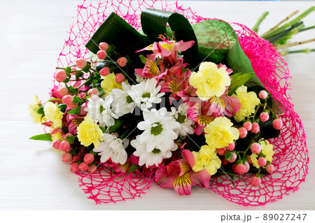 Beautiful bouquet of colorful flowers, white chrysanthemums and yellow carnation. Beautiful bouquet of colorful flowers, white chrysanthemums and yellow carnation. 89027247
