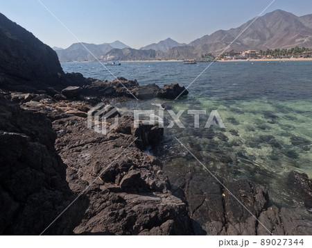 Incredible view from island to beach, small sandy beach on the island, coral reef, fujairah. High quality photo 89027344