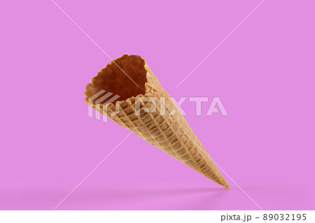 Empty, crunchy wafer cone for ice cream against pink background. Concept of food, treats. Mockup, template for your advertising and design. Close up 89032195