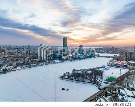Yekaterinburg aerial panoramic view in Winter at sunset. Yekaterinburg city and pond in winter. Yekaterinburg aerial panoramic view in Winter at sunset. Yekaterinburg city and pond in winter. 89039821