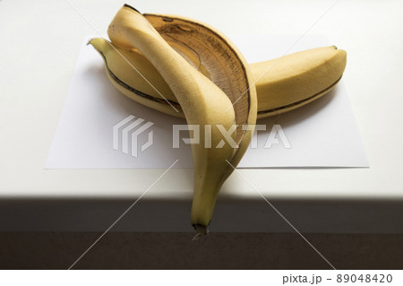 Banana skin on a white windowsill. Banana skin on a white windowsill. 89048420