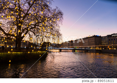 Geneve. Switzerland - December 30, 2021: Sunset over Geneva. Embankment of leman River Geneve. Switzerland - December 30, 2021: Sunset over Geneva. Embankment of leman River 89051611