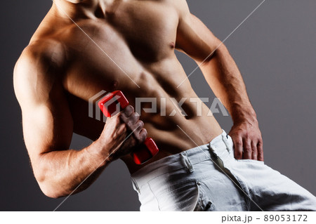 pain relief, sport, bodybuilding, strength and people concept - young man standing over black background 89053172
