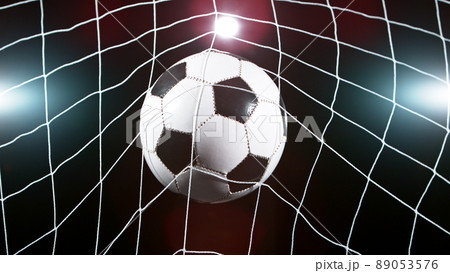 Soccer ball in goal, isolated on black background 89053576