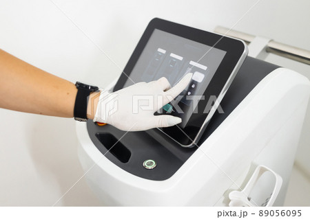 Doctor's hand adjusts the laser for epilation Doctor's hand adjusts the laser for epilation 89056095