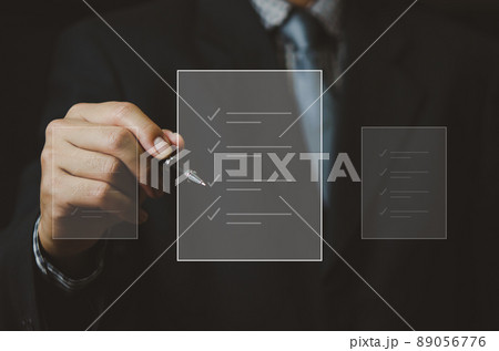 businessman holding pen to check business digital documents on virtual screen. businessman holding pen to check business digital documents on virtual screen. 89056776